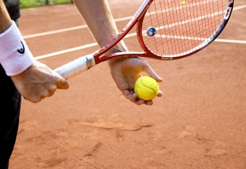 Nahaufnahme eines Tennisspielers, der bereit zum Aufschlag ist.