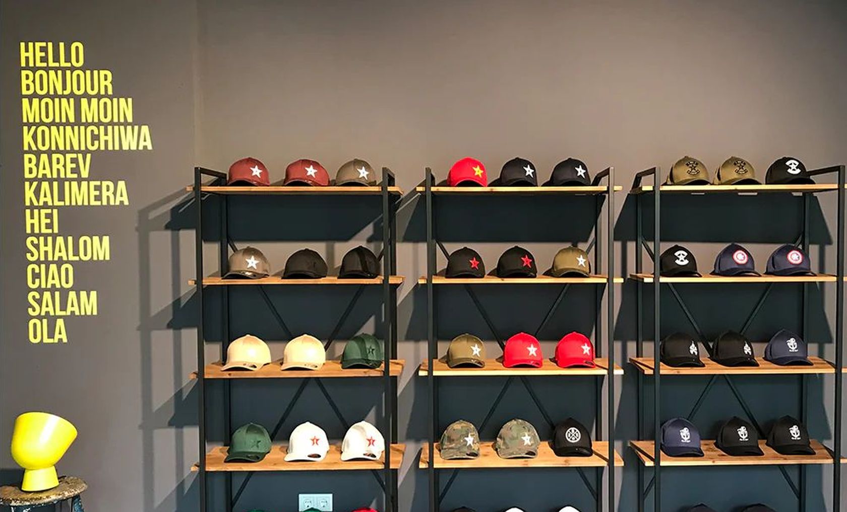 Modische Caps mit Druck liegen in Regalen aus. © null:zwo:elf