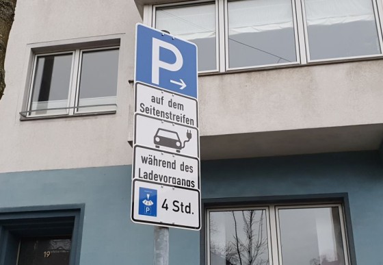 Nahaufnahme der Verkehrsschilder an einem Parkplatz für E-Autos.
